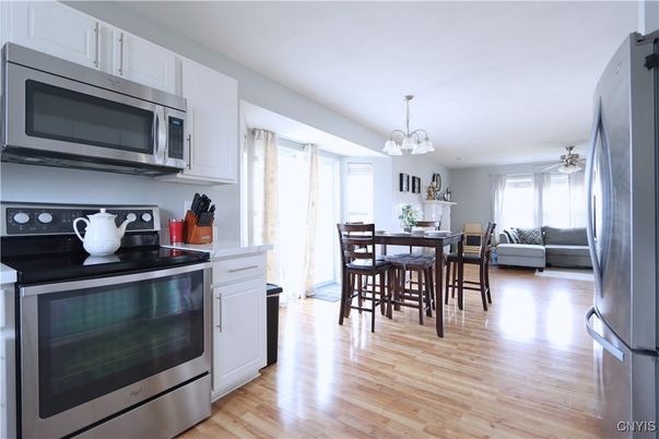 Chandelier, Dining room, Interior, Kitchen, Living room, Pendant Lights, Stainless Steel Appliances, Wood Texture Flooring