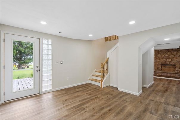 Empty room, Fireplace, Interior, Recessed Lighting, Stone Walls, Wood Texture Flooring