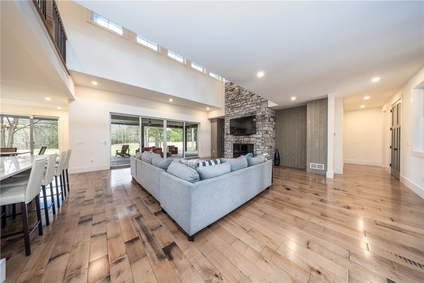 Fireplace, Interior, Living room, Recessed Lighting, Stone Walls, Wood Texture Flooring