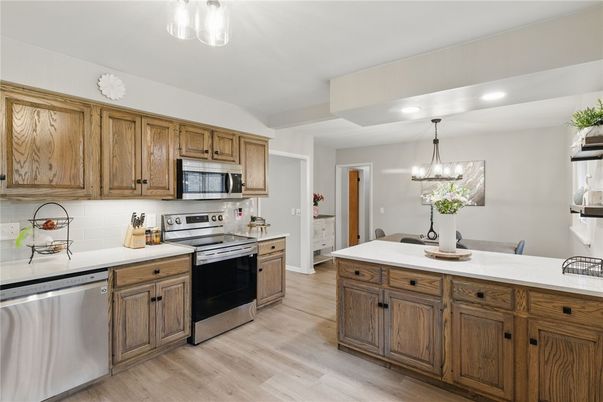 Dining room, Interior, Kitchen, Pendant Lights, Recessed Lighting, Stainless Steel Appliances, Wood Texture Flooring