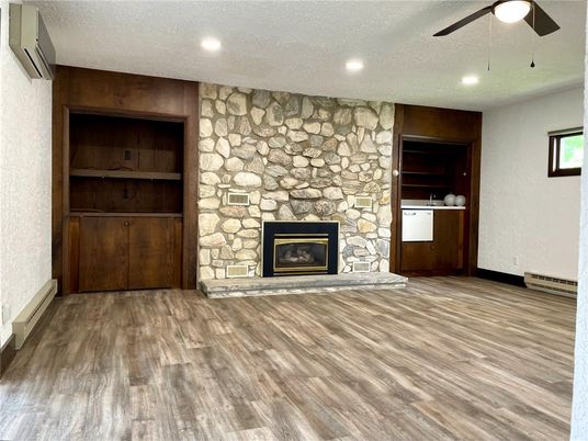 Empty room, Fireplace, Interior, Recessed Lighting, Stone Walls, Wood Texture Flooring