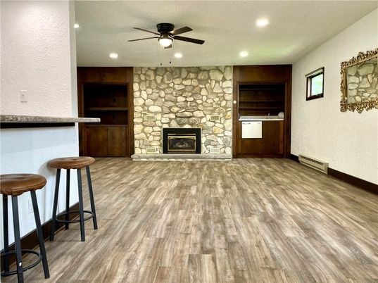 Empty room, Fireplace, Interior, Recessed Lighting, Stone Walls, Wood Texture Flooring