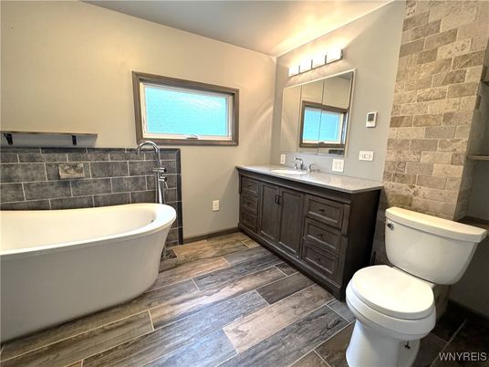 Bathroom, Dual Sink Vanities, Free Standing Baths, Interior, Stone Walls, Wood Texture Flooring