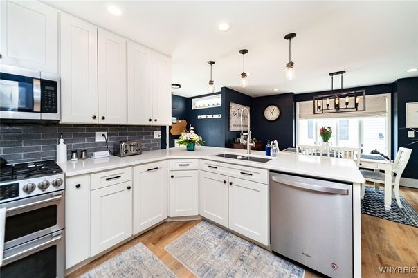 Dining room, Interior, Kitchen, Pendant Lights, Recessed Lighting, Stainless Steel Appliances, Wood Texture Flooring