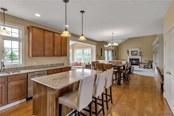 Chandelier, Dining room, Fireplace, Interior, Kitchen, Living room, Pendant Lights, Recessed Lighting, Stainless Steel Appliances, Wood Texture Flooring