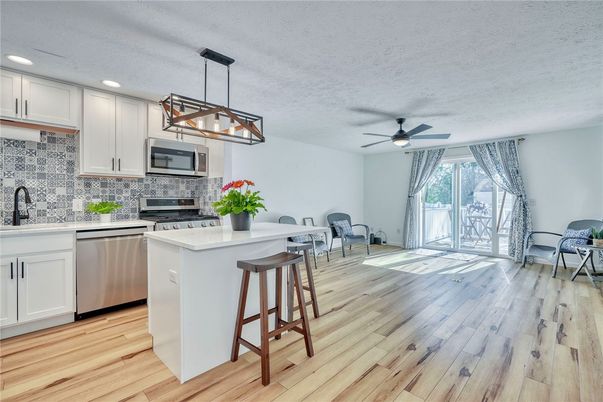 Dining room, Interior, Kitchen, Pendant Lights, Recessed Lighting, Stainless Steel Appliances, Wood Texture Flooring