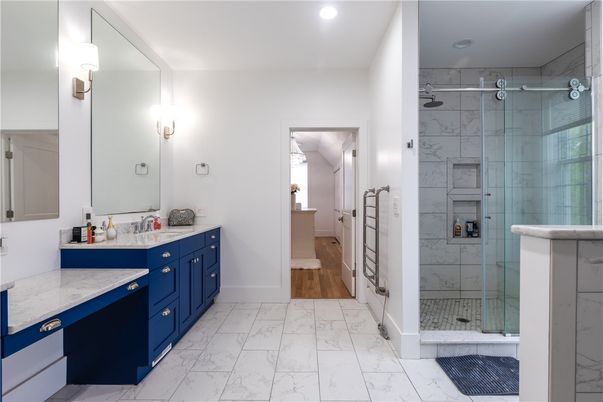 Bathroom, Dual Sink Vanities, Glass Shower, Interior, Marble, Marble Walls, Recessed Lighting, Wood Texture Flooring