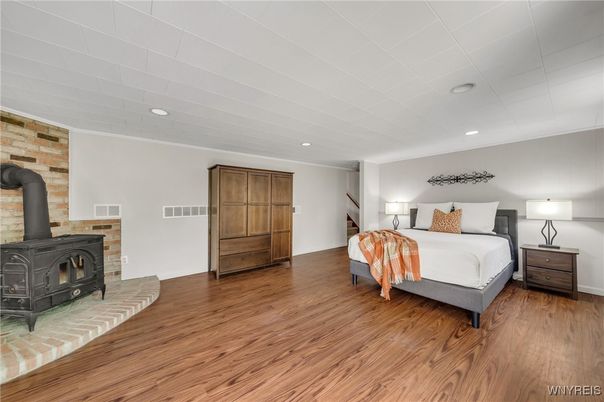 Bedroom, Fireplace, Interior, Recessed Lighting, Stone Walls, Wood Texture Flooring