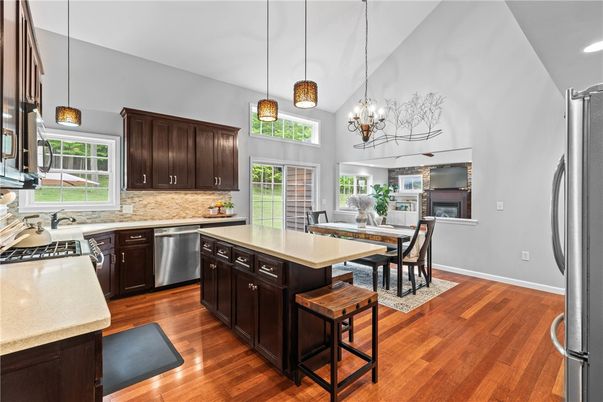 Chandelier, Dining room, Interior, Kitchen, Pendant Lights, Recessed Lighting, Stainless Steel Appliances, Wood Texture Flooring
