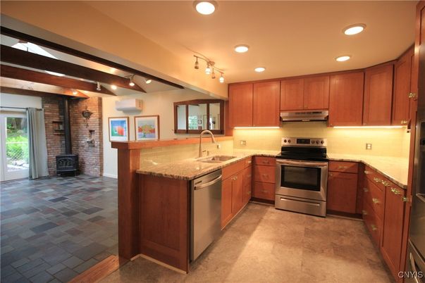 Fireplace, Interior, Kitchen, Recessed Lighting, Stainless Steel Appliances, Stone Walls