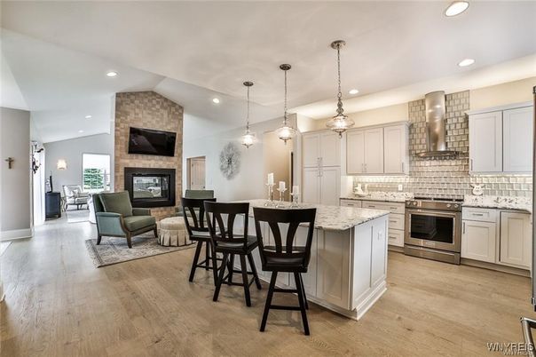 Fireplace, Interior, Kitchen, Living room, Pendant Lights, Recessed Lighting, Stainless Steel Appliances, Stone Walls, Wood Texture Flooring