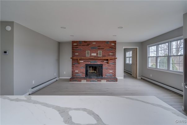 Empty room, Fireplace, Interior, Recessed Lighting, Stone Walls, Wood Texture Flooring