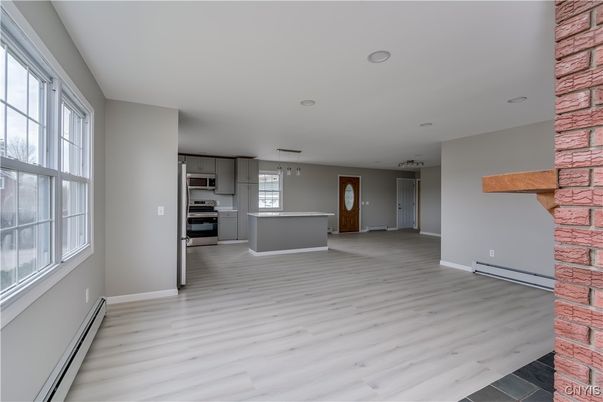 Empty room, Interior, Kitchen, Pendant Lights, Recessed Lighting, Stainless Steel Appliances, Wood Texture Flooring