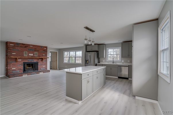 Fireplace, Interior, Kitchen, Pendant Lights, Recessed Lighting, Stainless Steel Appliances, Stone Walls, Wood Texture Flooring