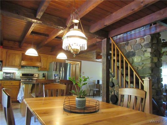 Chandelier, Dining room, Interior, Kitchen, Pendant Lights, Stainless Steel Appliances, Stone Walls, Wooden Beams, Wooden Ceilings