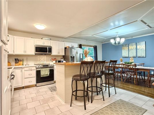 Chandelier, Dining room, Interior, Kitchen, Stainless Steel Appliances, Wood Texture Flooring
