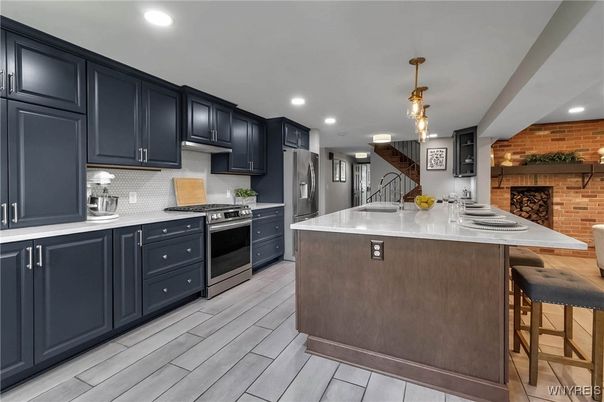 Interior, Kitchen, Pendant Lights, Recessed Lighting, Stainless Steel Appliances, Stone Walls, Wood Texture Flooring, Wooden Walls