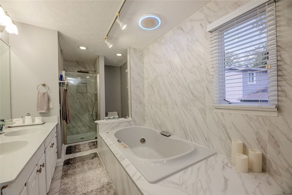 Bathroom, Dual Sink Vanities, Glass Shower, Interior, Marble, Marble Walls, Recessed Lighting