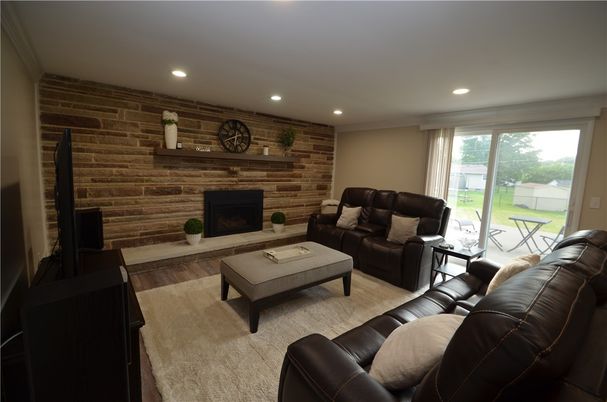 Fireplace, Interior, Living room, Recessed Lighting, Stone Walls, Wood Texture Flooring, Wooden Walls