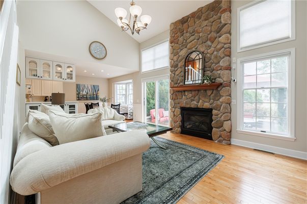 Chandelier, Fireplace, Interior, Living room, Recessed Lighting, Stone Walls, Wood Texture Flooring