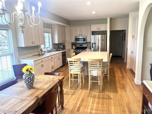 Chandelier, Dining room, Interior, Kitchen, Recessed Lighting, Stainless Steel Appliances, Wood Texture Flooring