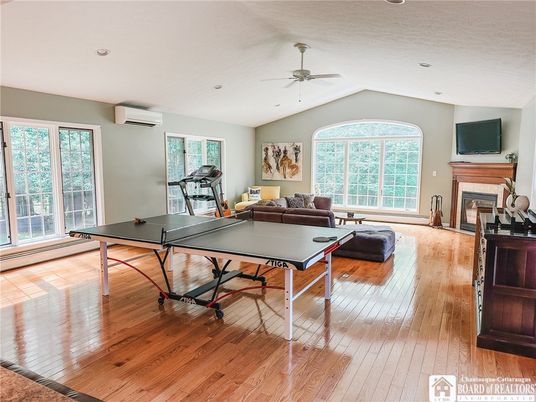 Fireplace, Fitness Equipment, Game Room, Interior, Living room, Recessed Lighting, Wood Texture Flooring