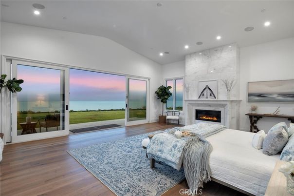 Bedroom, Fireplace, Interior, Marble Walls, Recessed Lighting, Water, Wood Texture Flooring