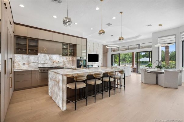 Dining room, Interior, Kitchen, Marble Walls, Pendant Lights, Recessed Lighting, Stainless Steel Appliances, Wood Texture Flooring