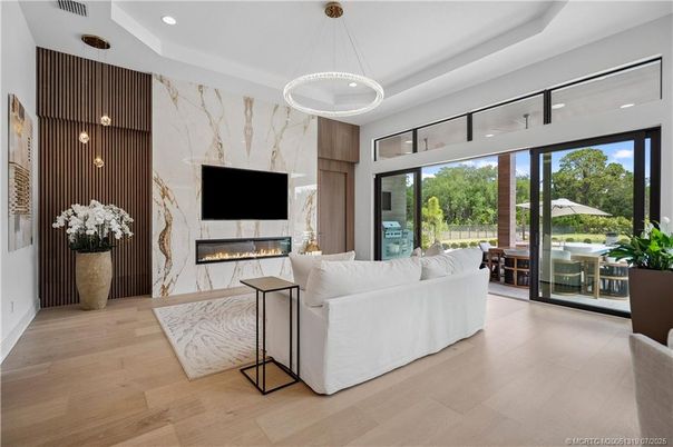 Fireplace, Interior, Living room, Marble Walls, Pendant Lights, Recessed Lighting, Wood Texture Flooring