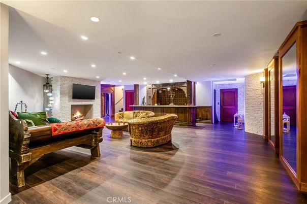 Fireplace, Interior, Living room, Recessed Lighting, Stone Walls, Wood Texture Flooring