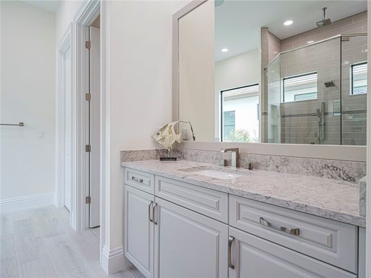 Bathroom, Dual Sink Vanities, Glass Shower, Interior, Recessed Lighting, Wood Texture Flooring