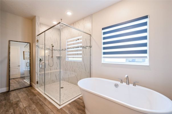 Bathroom, Free Standing Baths, Glass Shower, Interior, Marble Walls, Recessed Lighting, Wood Texture Flooring