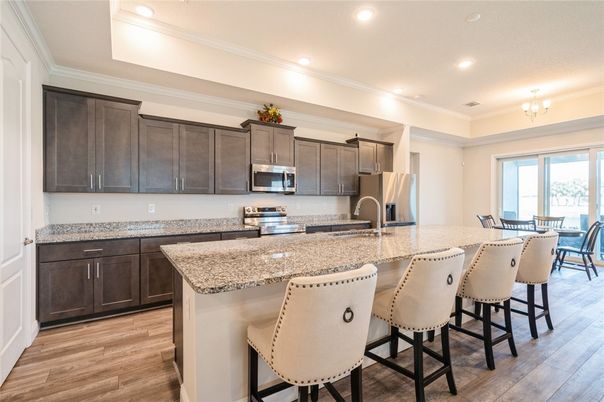 Chandelier, Dining room, Interior, Kitchen, Recessed Lighting, Stainless Steel Appliances, Wood Texture Flooring