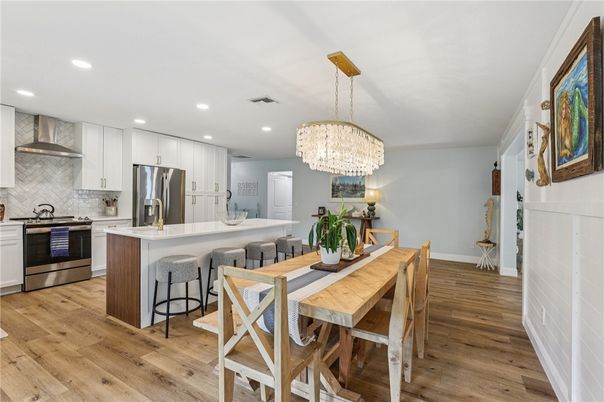 Chandelier, Dining room, Interior, Kitchen, Recessed Lighting, Stainless Steel Appliances, Wood Texture Flooring