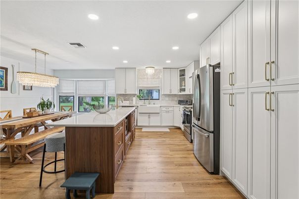 Chandelier, Dining room, Interior, Kitchen, Recessed Lighting, Stainless Steel Appliances, Wood Texture Flooring