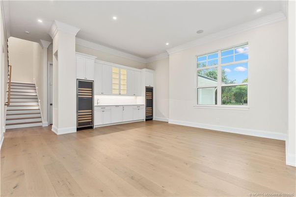 Empty room, Interior, Kitchen, Recessed Lighting, Stainless Steel Appliances, Wood Texture Flooring