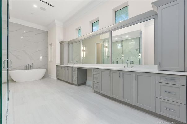 Bathroom, Dual Sink Vanities, Free Standing Baths, Glass Shower, Interior, Marble Walls, Recessed Lighting, Wood Texture Flooring
