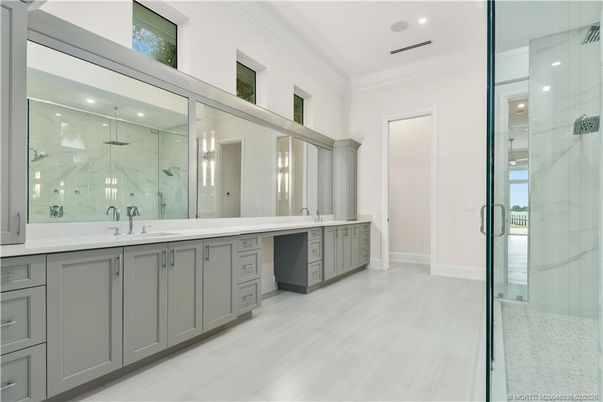 Bathroom, Dual Sink Vanities, Glass Shower, Interior, Marble Walls, Recessed Lighting, Wood Texture Flooring