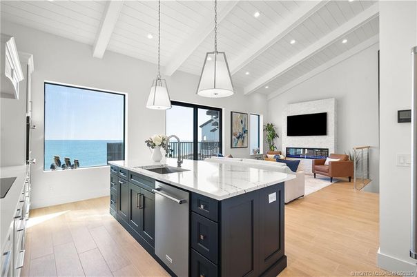 Fireplace, Interior, Kitchen, Living room, Pendant Lights, Recessed Lighting, Stainless Steel Appliances, Water, Wood Texture Flooring