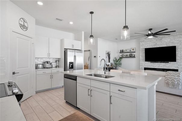 Fireplace, Interior, Kitchen, Pendant Lights, Recessed Lighting, Stainless Steel Appliances, Stone Walls, Wood Texture Flooring