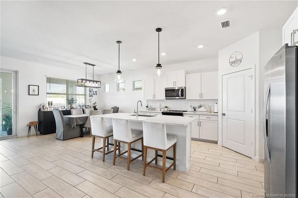 Dining room, Interior, Kitchen, Pendant Lights, Recessed Lighting, Stainless Steel Appliances, Wood Texture Flooring