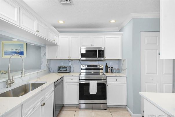 Interior, Kitchen, Marble Walls, Recessed Lighting, Stainless Steel Appliances