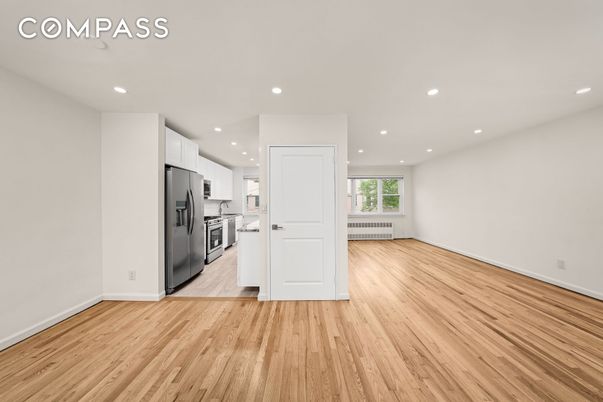 Empty room, Interior, Kitchen, Recessed Lighting, Stainless Steel Appliances, Wood Texture Flooring