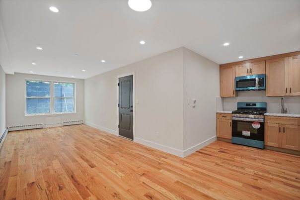 Empty room, Interior, Kitchen, Recessed Lighting, Stainless Steel Appliances, Wood Texture Flooring