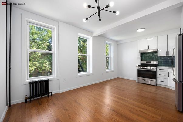 Empty room, Interior, Kitchen, Pendant Lights, Recessed Lighting, Stainless Steel Appliances, Wood Texture Flooring