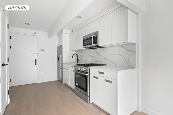 Interior, Kitchen, Marble Walls, Recessed Lighting, Stainless Steel Appliances, Wood Texture Flooring