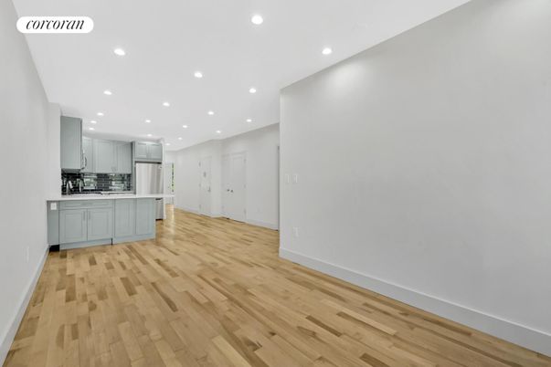 Empty room, Interior, Kitchen, Recessed Lighting, Stainless Steel Appliances, Wood Texture Flooring