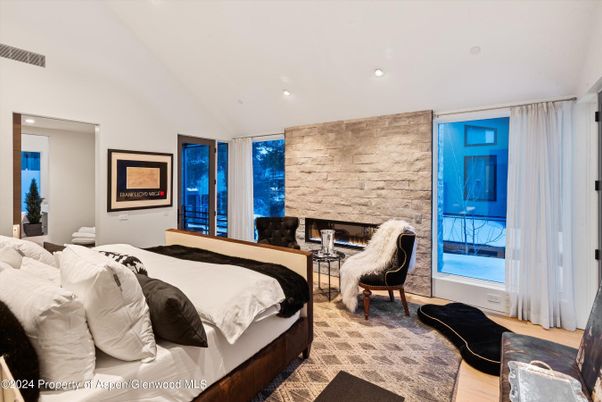 Bedroom, Fireplace, Interior, Recessed Lighting, Stone Walls, Wood Texture Flooring