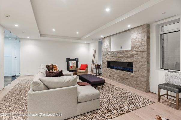Fireplace, Interior, Living room, Recessed Lighting, Stone Walls, Wood Texture Flooring