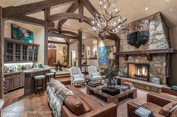 Chandelier, Fireplace, Interior, Living room, Recessed Lighting, Stone Walls, Wooden Beams